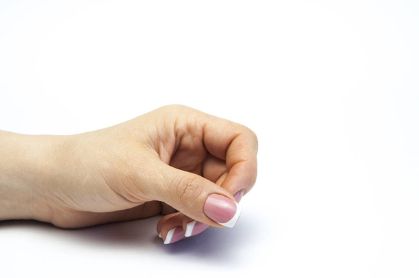 Woman's hand with french manicure. On white background - Foto, Imagen