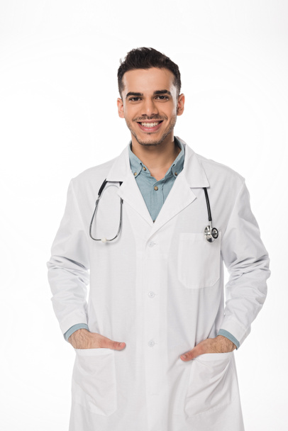 Smiling doctor with stethoscope looking at camera isolated on white - Photo, Image
