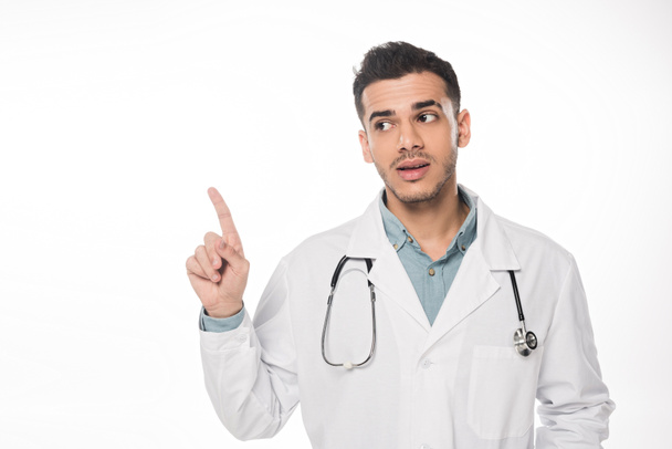 Handsome doctor pointing with finger isolated on white - Foto, Bild