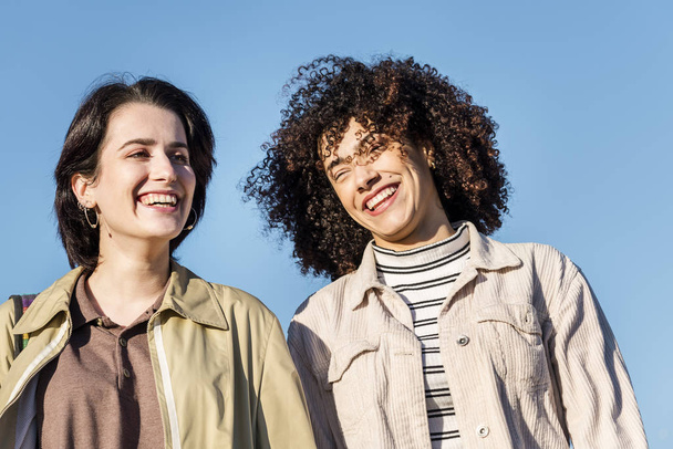 multiracial couple of young women laughing funny - Foto, Imagen