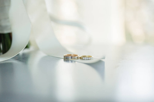 Gold wedding rings on a light background. - Photo, Image