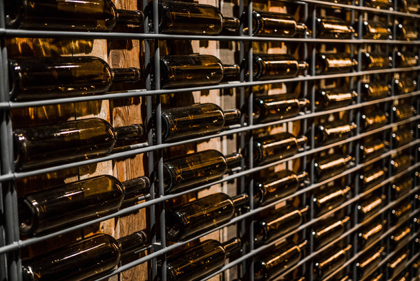 empty wine bottles on a shelf. wine Vault. wine bottle wall - Photo, Image