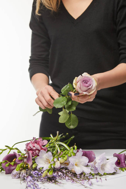 cropped view of florist holding rose isolated on white - Zdjęcie, obraz