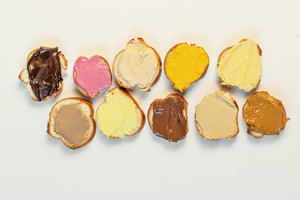 Assorted sweet cream on baguette. Confectionery, sweet life, calories. - Photo, Image