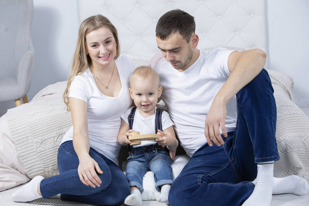 Mom, dad and little son are playing at home. Young family with a child. - Photo, Image