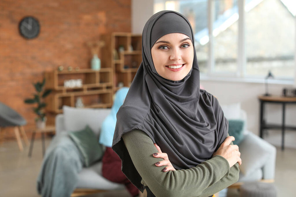 Beautiful young Muslim woman at home - Photo, Image