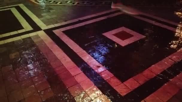 Zware regenval 's nachts in Kadikoy Istanbul, mensen lopen op mooie kasseien van de straat. - Video