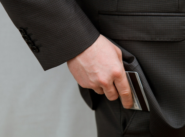Businessman putting a credit card in a pocket - Φωτογραφία, εικόνα