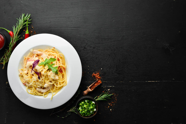 Pasta with chicken meat and cheese. Italian cuisine. Top view. Free space for your text. - Foto, Imagen