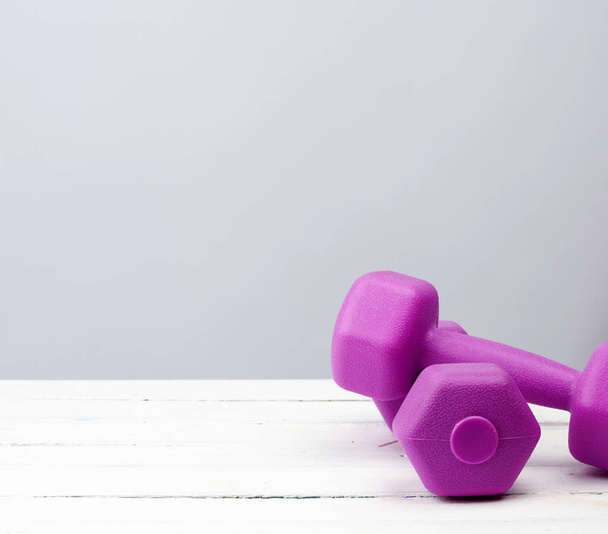 pair of purple plastic dumbbell for sports, - Photo, image
