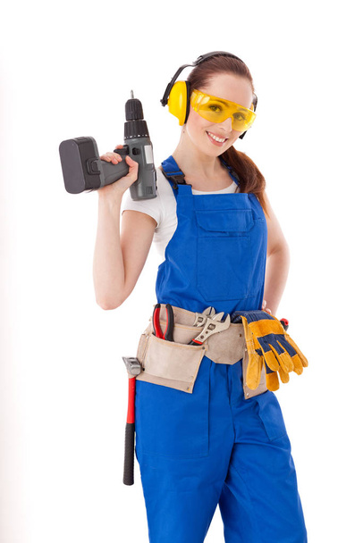 Young woman in  coverall with screwdriver on a white background. Female construction worker. - Fotó, kép
