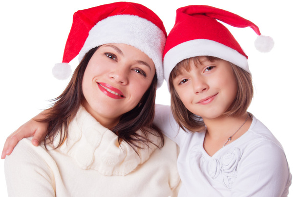 Smiling mother and daughter in Santa hats - Foto, Imagen