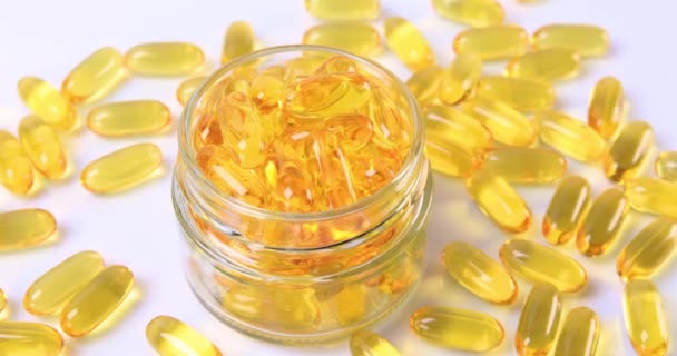 Omega fish oil softgels dietary supplement in jar. Healthy life and heart health concept. Dolly shot 4k - 映像、動画