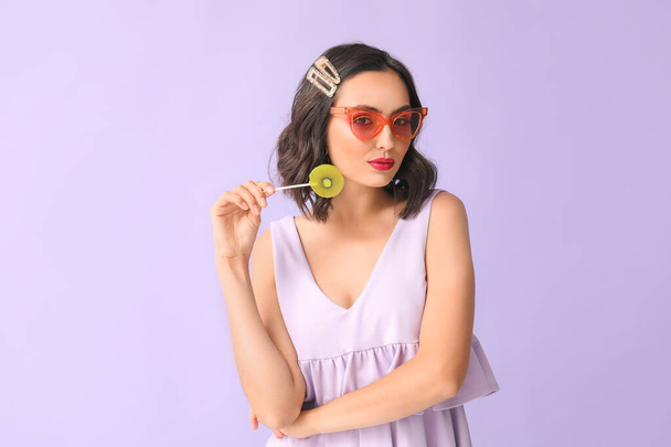 Beautiful young woman with lollipop on color background - Φωτογραφία, εικόνα