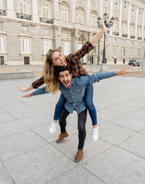 Young happy friends tourist couple having fun while traveling on a romantic trip around Europe. European city urban background. In tourism and vacations concept. - Zdjęcie, obraz