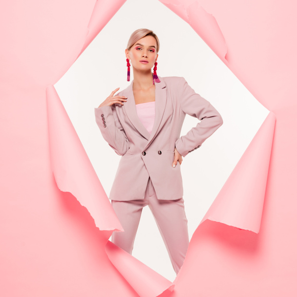fashionable woman in trendy suit posing in torn paper, isolated on white - Фото, изображение