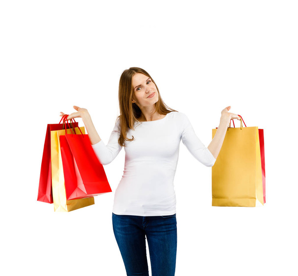 Cute woman holding shopping bags isolated on white background - Fotoğraf, Görsel