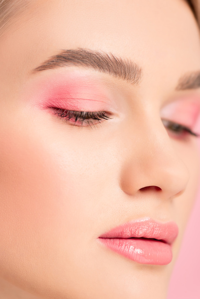 close up of attractive girl with pink makeup, isolated on pink - Фото, изображение