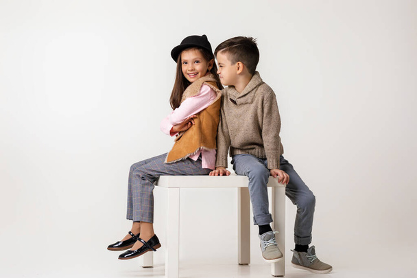 Cute stylish little couple child girl and boy sittting together . - Фото, зображення