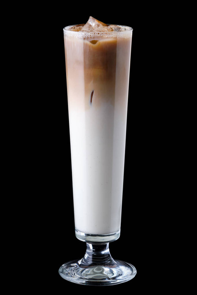 Tall narrow glass with iced coffee isolated on black - Фото, изображение