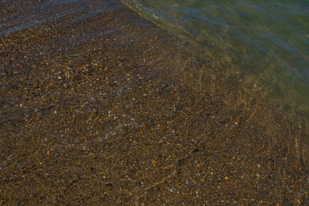 Ondas y arena negra de origen volcánico. Baia Domizia Coast, Provincia de Caserta, Italia
 - Foto, imagen