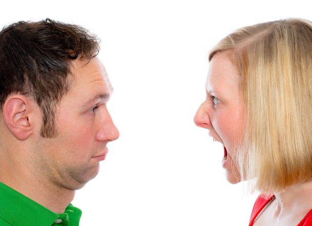 young man scream at so his wife in front of white background - 写真・画像