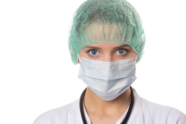 portrait of a female doctor waering breathing protection and a hair net - Фото, изображение