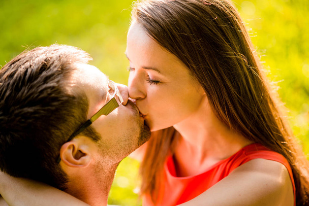 Romantic young couple hugging and kissing in nature - Foto, Imagem