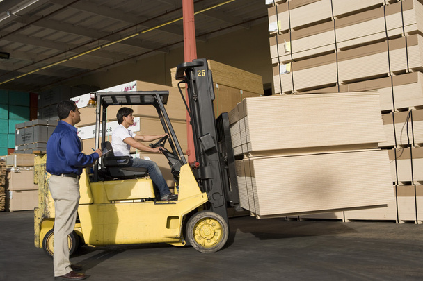 Warehouseman and forklift truck driver - Photo, image