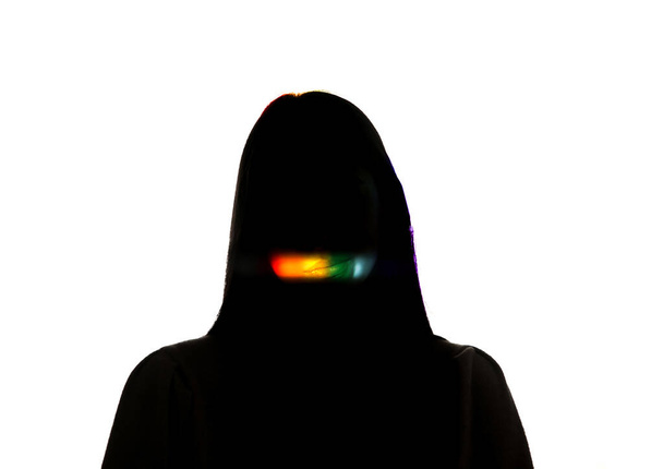Dramatic portrait of a girl in the dark on white studio background with rainbow colored line - Photo, Image
