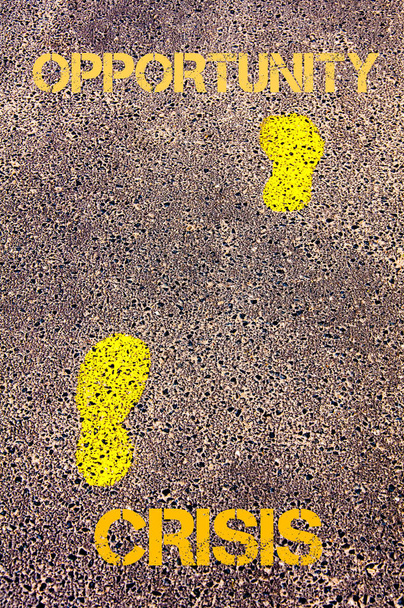 Yellow footsteps on sidewalk from Opportunity to Crisis message. Conceptual image - Foto, afbeelding