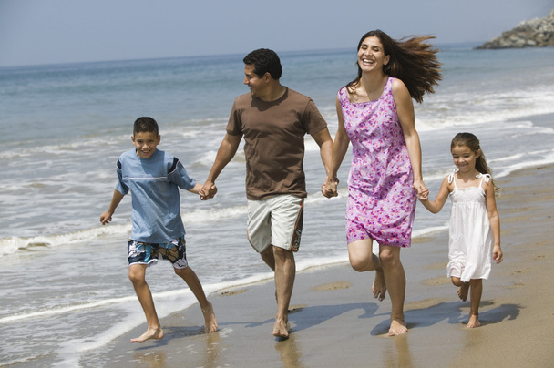 Family Walking on the Beach - 写真・画像