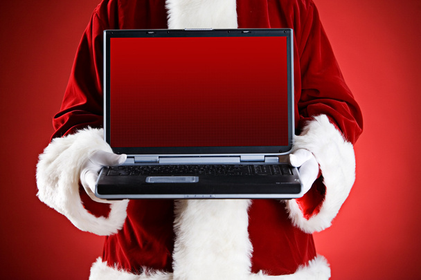 Santa: Tenendo un computer portatile con schermo vuoto
 - Foto, immagini
