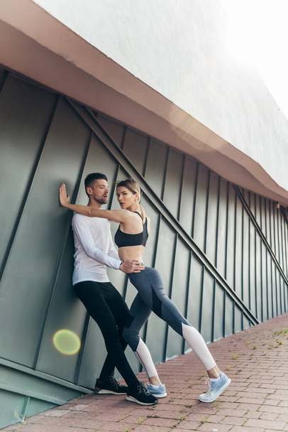 Fitness couple standing outdoors. Sport, workout, healthy lifestyle concept. - Valokuva, kuva