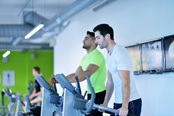 group of young people running on treadmills in modern sport  gym - Foto, Imagen