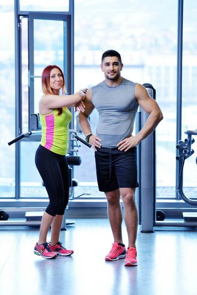 attractive couple at the gym looking happy - Фото, изображение