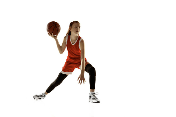 Young caucasian female basketball player against white studio background - Foto, afbeelding