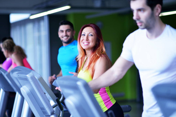 group of young people running on treadmills in modern sport  gym - Photo, Image