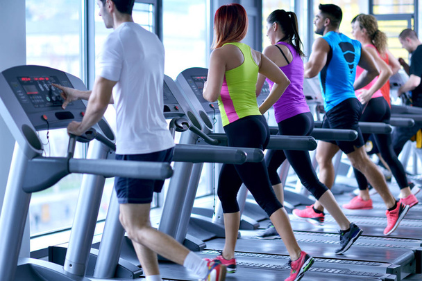 group of young people running on treadmills in modern sport  gym - 写真・画像