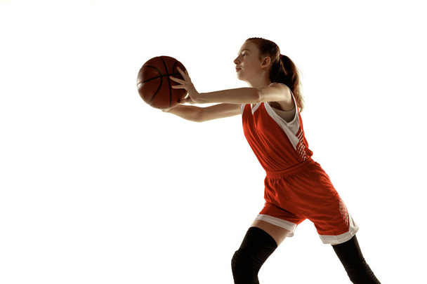 Young caucasian female basketball player against white studio background - Zdjęcie, obraz