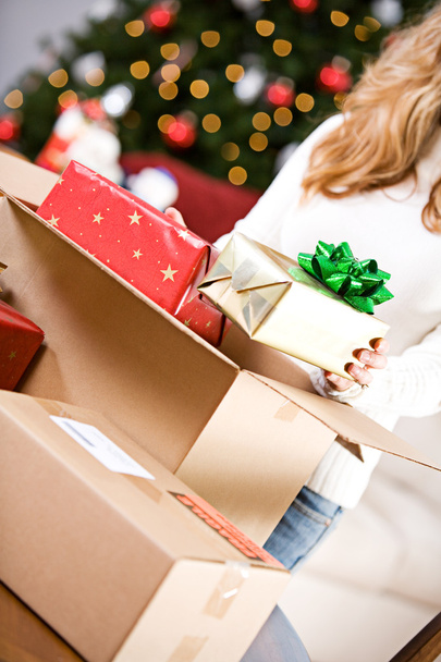 Christmas: Putting Wrapped Gifts In Box - Foto, imagen