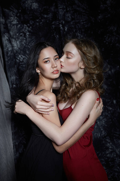 Beauty spring portrait of two girls on a dark background. Women  - Фото, зображення