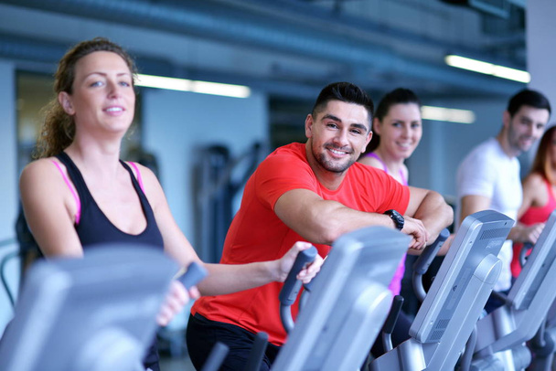group of young people running on treadmills in modern sport  gym - 写真・画像
