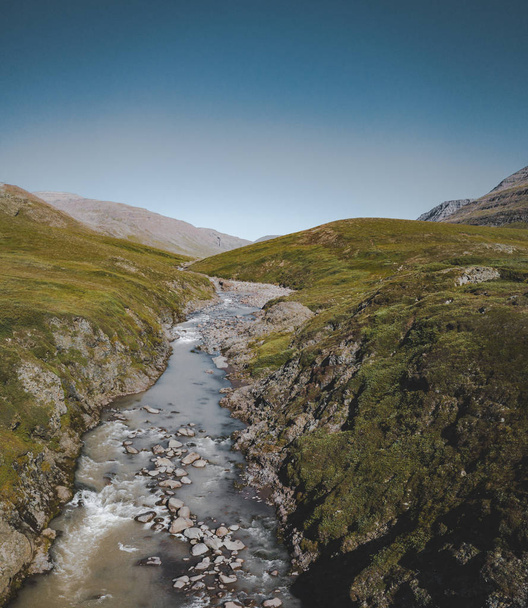 Panorama aerial view of a hiking area in a rocky environment with arctic meadows in summer. River on Island of kuannit, Disko Island in Greenland. - Foto, Bild