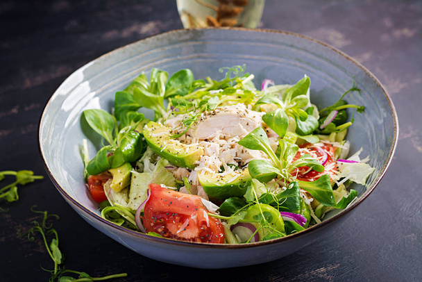 Fresh salad with chicken breast, corn salad, cucumber, avocado and tomato. Chicken salad. Italian cuisine. Healthy food concept. - Photo, Image