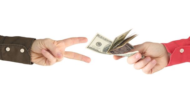 The hand reaches for the hand with the money. Payment for work.  - Photo, Image