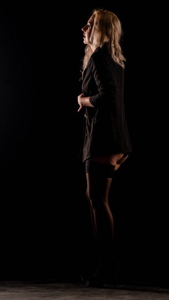 Sexy woman in black shirt posing in dark studio  - Фото, изображение