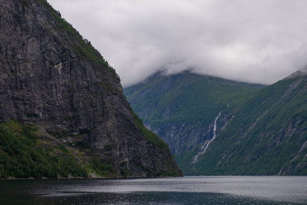 Little waterfall. Views inside the Geiranger fjord taken by the ferry hellesylt geiranger. July 2019 - Photo, Image