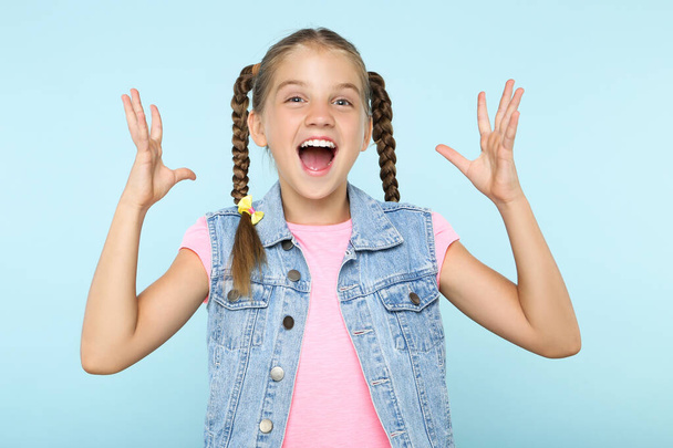 Young happy girl on blue background - Foto, Imagem