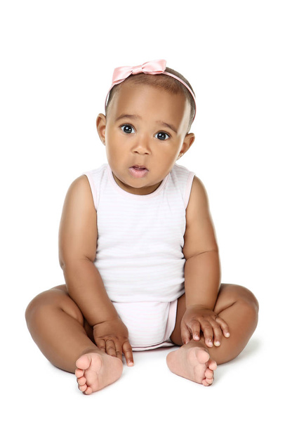 American baby girl sitting on white background - Foto, Bild